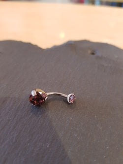 Rhodolite prong set navel bar.